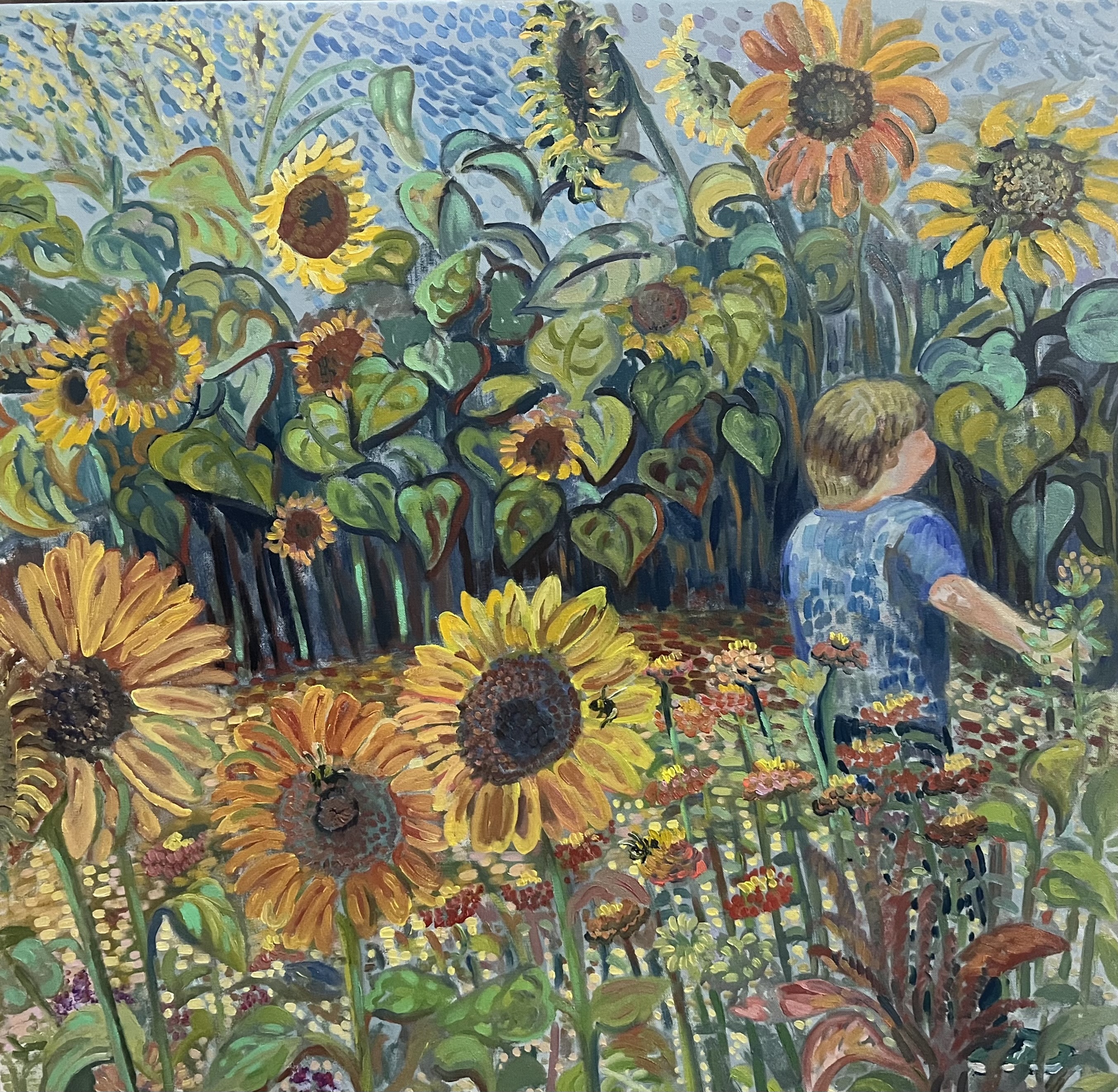 Boy runs through sunflower garden